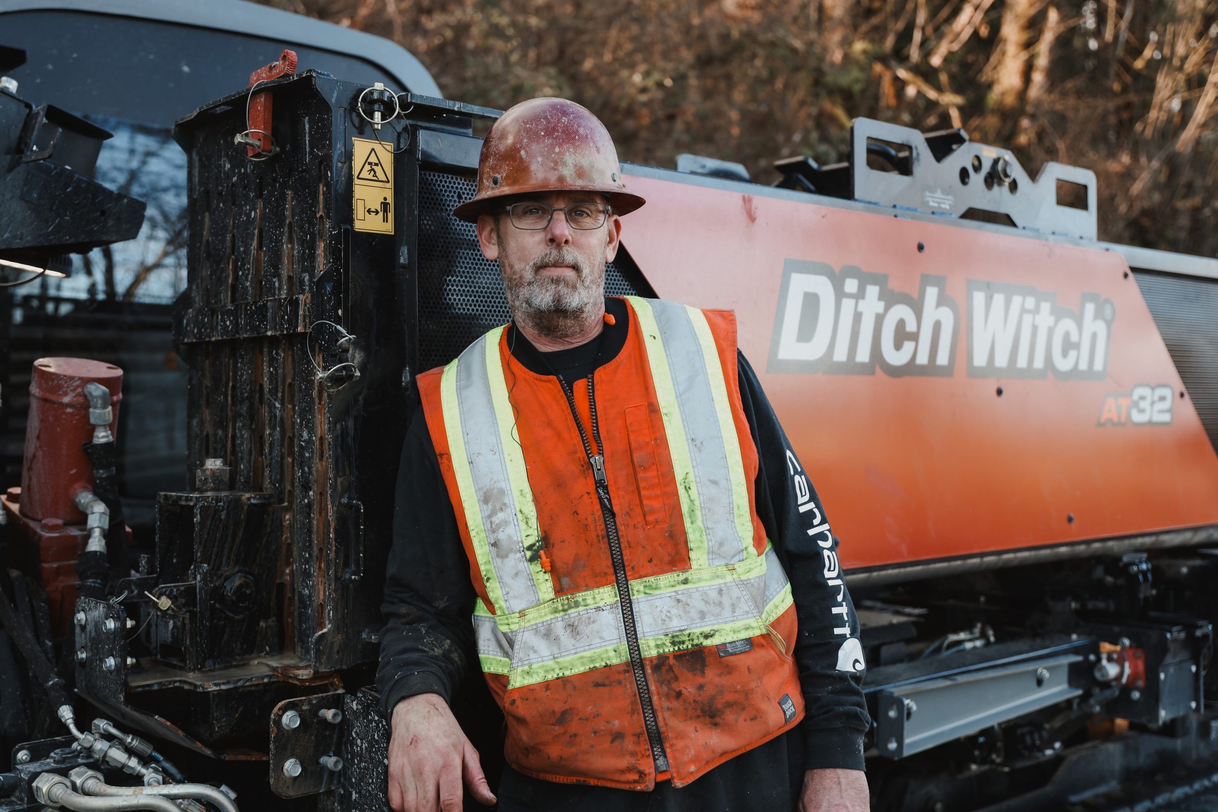 Operator portrait next to Ditch Witch AT32